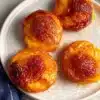 Delicious air fryer peaches served in a bowl with a drizzle of honey.