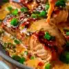 Bang Bang Salmon dish garnished with fresh herbs and spicy sauce