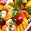 Burrata peach salad with creamy cheese and ripe peaches served on a plate