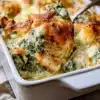 Creamy chicken spinach artichoke casserole baked in a dish