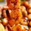 Grilled Chipotle Honey Shrimp Skewers on a platter with garnish