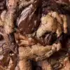 Freshly baked coffee toffee cookies with chocolate drizzle and toffee chunks.