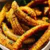 Deliciously grilled corn ribs served with herbs and spices.