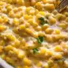 Delicious bowl of homemade creamed corn served with fresh herbs.