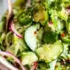 Fresh cucumber salad with a mix of crunchy vegetables in a bowl