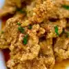 Crispy and golden fried chicken served on a plate with sides.