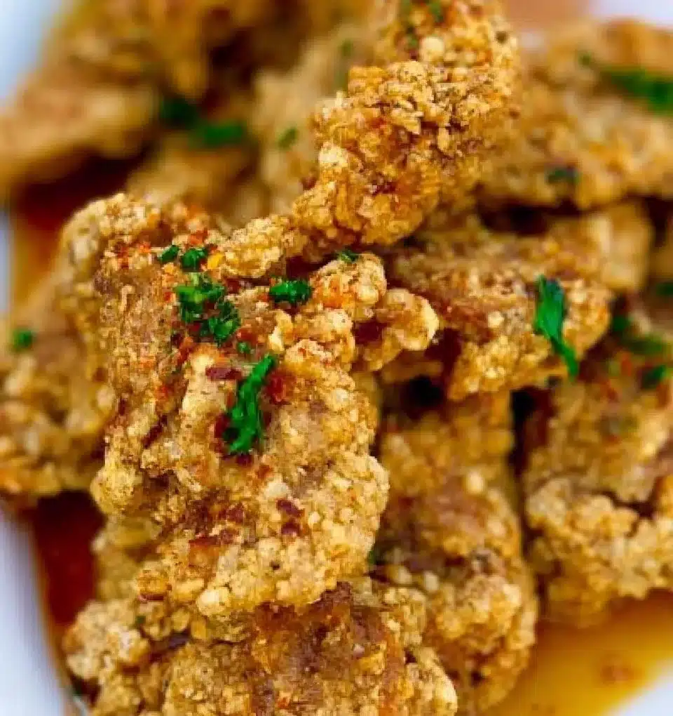 Crispy and golden fried chicken served on a plate with sides.