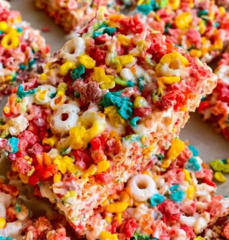 Colorful Fruity Pebbles Rice Krispie Treats stacked on a plate