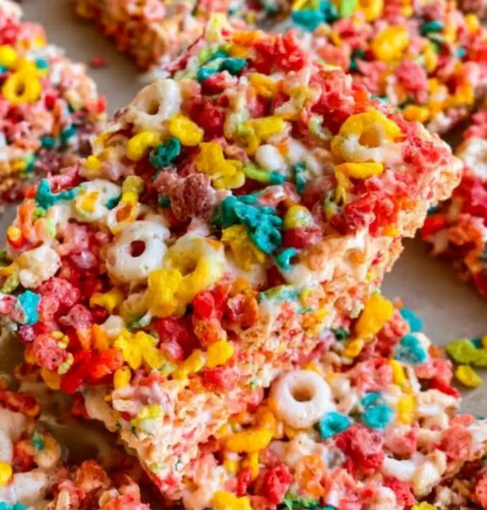Colorful Fruity Pebbles Rice Krispie Treats stacked on a plate