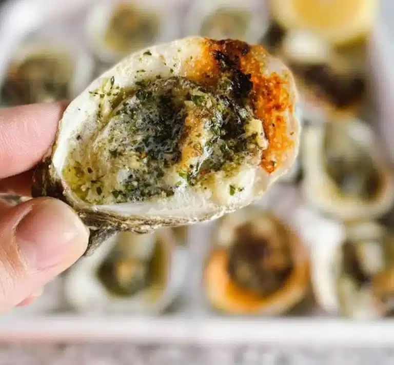 Delicious Garlic Butter Oysters garnished with herbs and served on a plate