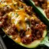 Delicious ground beef zucchini boats topped with cheese and herbs
