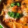 Bowl of delicious lasagna soup with cheese and herbs