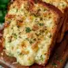 Delicious Mozzarella Parmesan Garlic Bread topped with melted cheese and garlic.