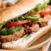 Oyster Mushroom Po Boy sandwich with lettuce and sauce on a bun