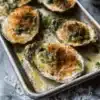 Delicious Oysters Rockefeller topped with spinach and herbs, ready to enjoy.