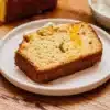 Homemade Peach Bread fresh out of the oven with slices on a wooden table