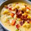 Bowl of creamy potato corn chowder with herbs and fresh ingredients