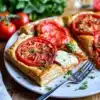 Delicious puff pastry tomato tart topped with fresh tomatoes and herbs