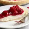 Slice of raspberry cream pie with fresh raspberries on top