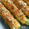 Delicious street corn topped with cheese, spices, and lime.