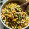 Delicious Street Corn Salad topped with cheese and spices in a vibrant bowl.