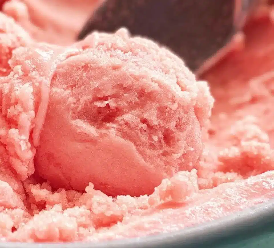 Delicious homemade Watermelon Ice Cream served in a bowl on a sunny day.