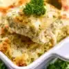 A delicious serving of white chicken lasagna topped with herbs and cheese.