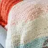 Cozy and colorful crochet blanket displayed on a comfortable sofa