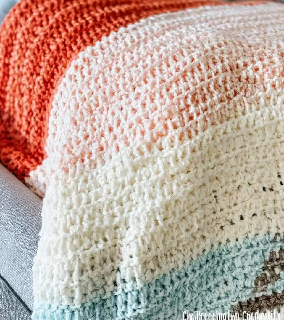 Cozy and colorful crochet blanket displayed on a comfortable sofa