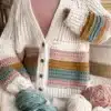 Handmade crochet cardigan in soft yarn, perfect for layering and style.