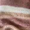 Cozy striped blanket adding style and warmth to home decor